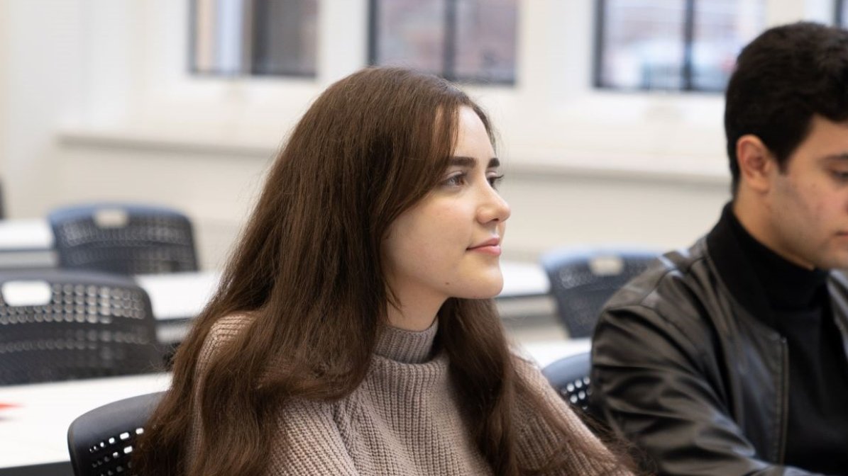 Students in classroom writing personal statements