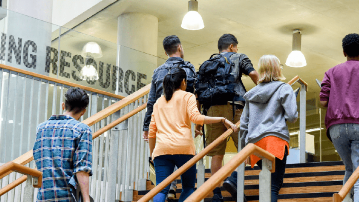 Students climbing stairs in university