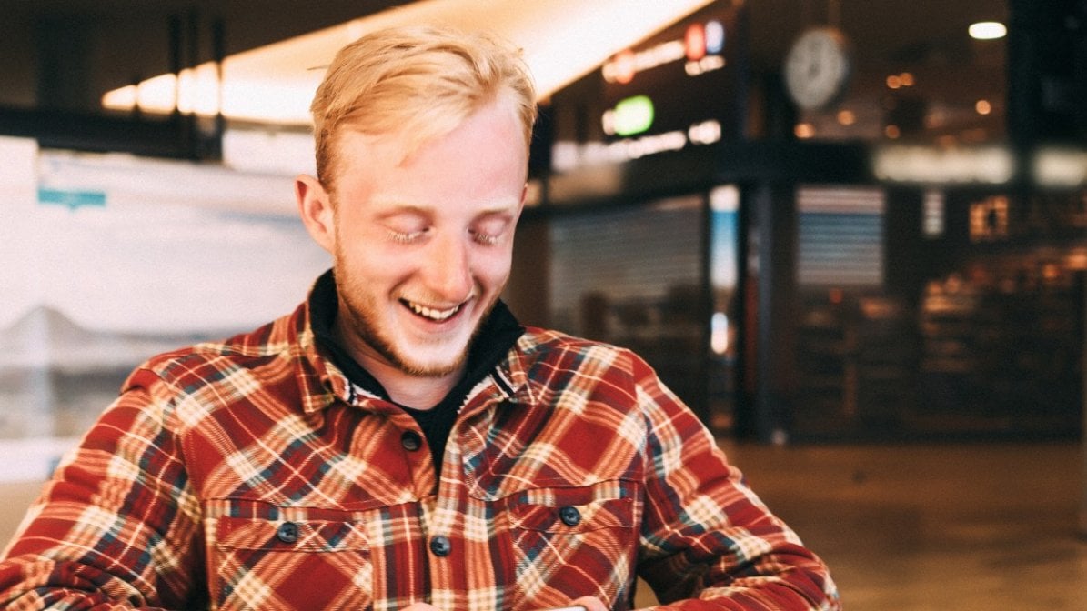 Apprentice smiling at his phone