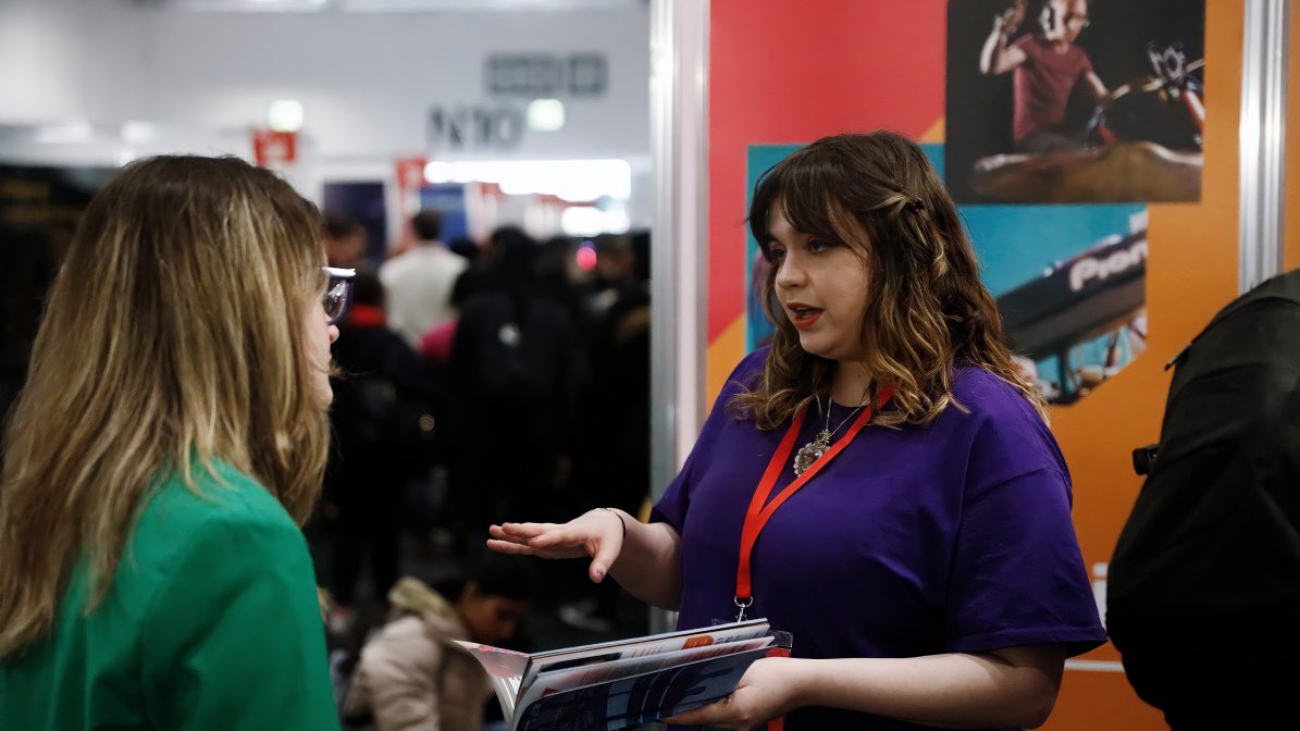 company talking to students at ucas event