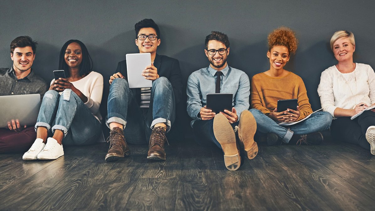 Recent graduates sat together searching for jobs