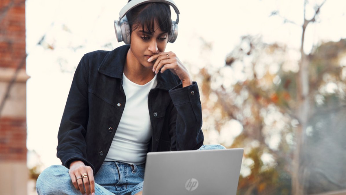 Student using headphones and using laptop