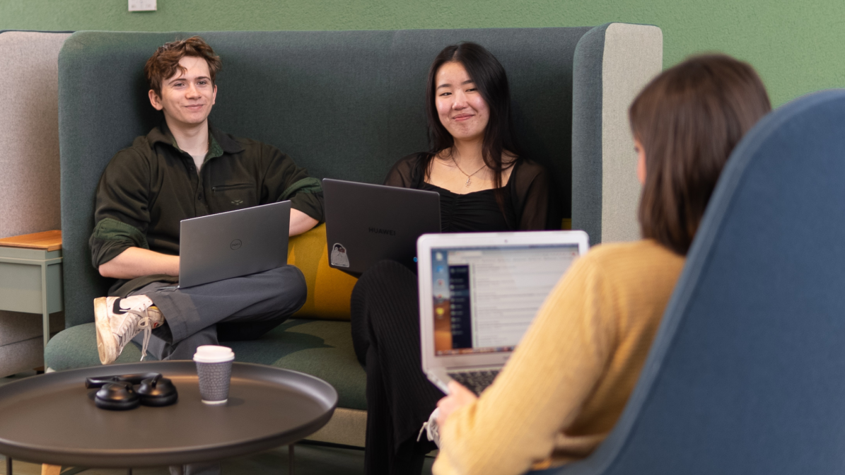 A group of students sat in a communal working space