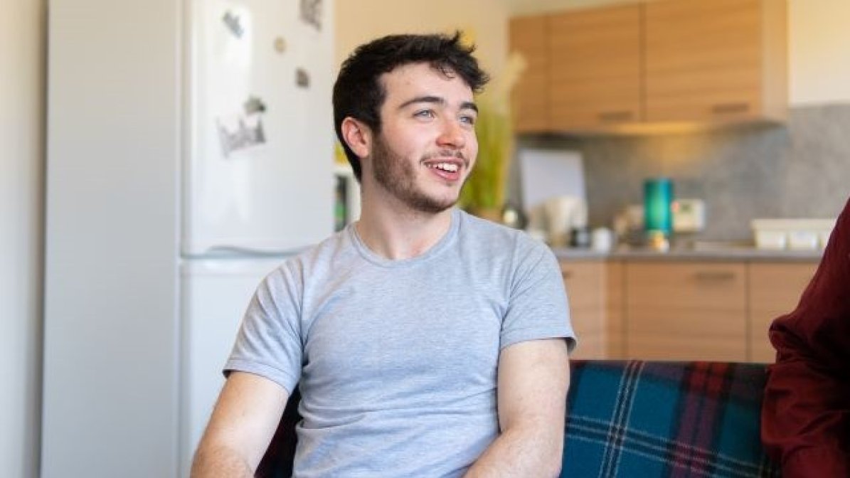Student in kitchen of shared accommodation