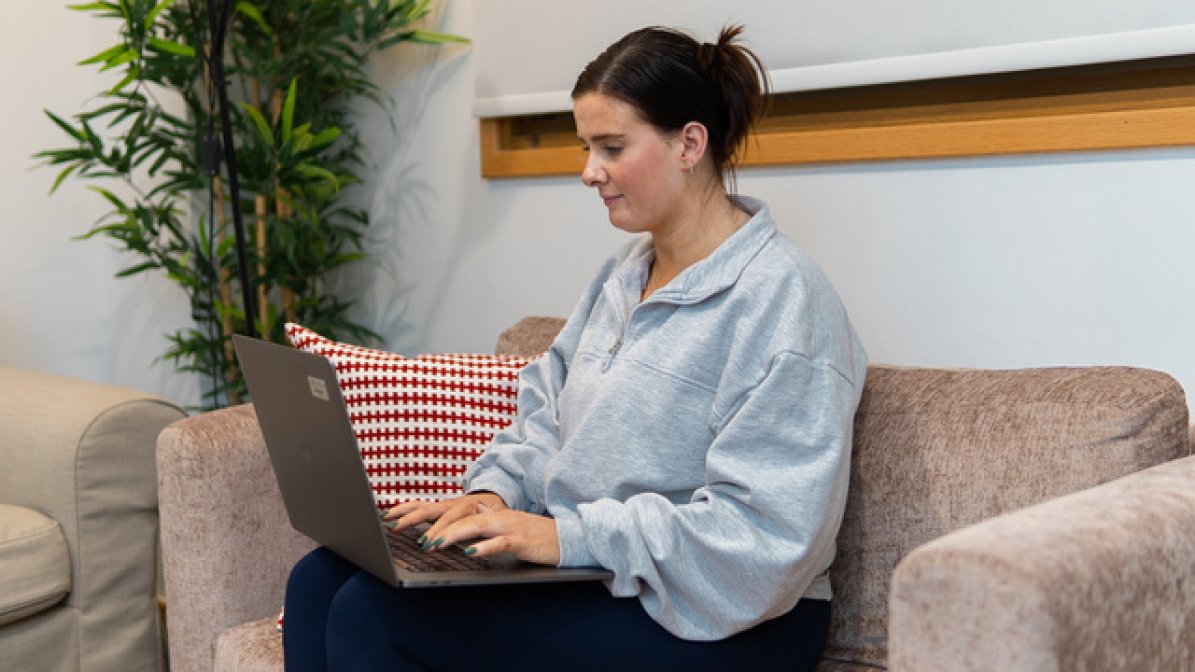 Care experienced apprentice working on laptop at home