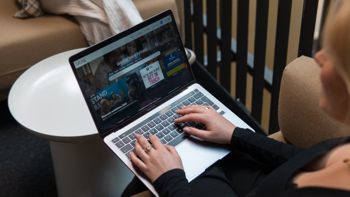 Student using laptop to research contextual offers