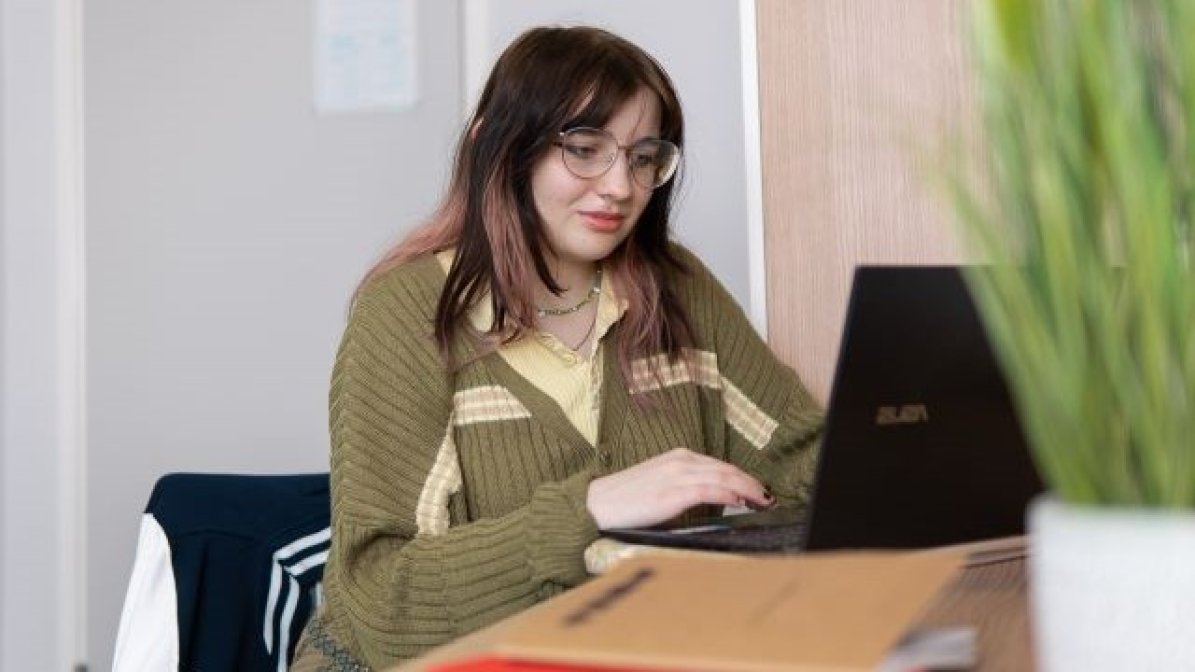 Student using laptop at desk