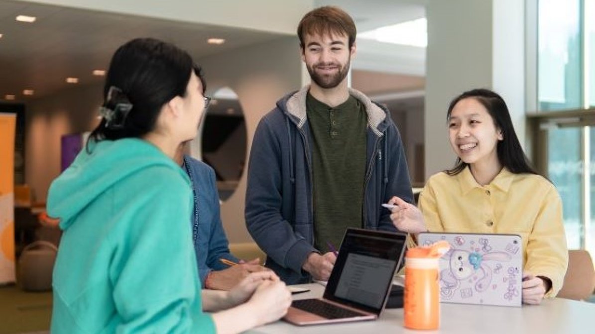 Students using laptops in communal area