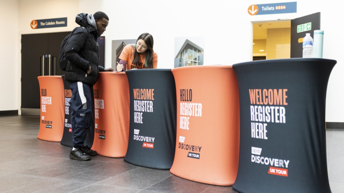 Delegate manager registering person at an event