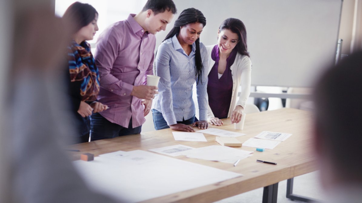 Workplace health consultant with employees in workshop