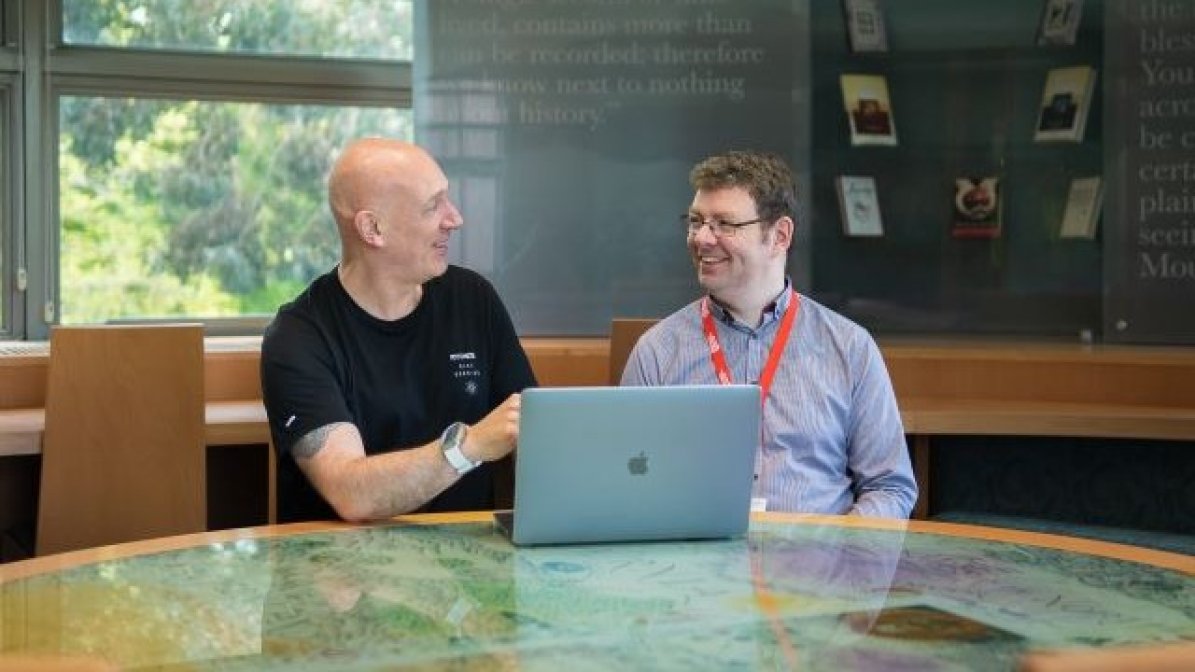 Advisers using laptop at desk