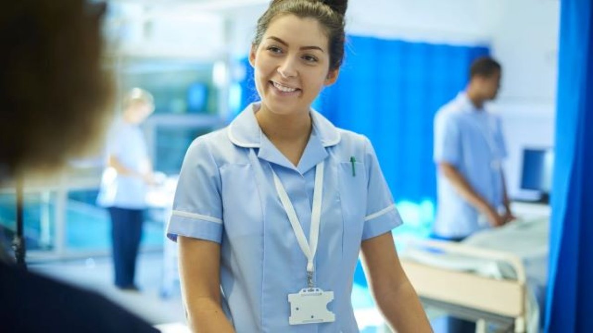 Nursing student in hospital ward  
