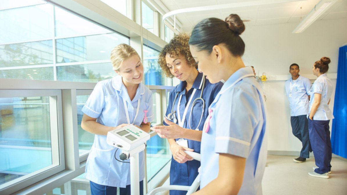 Nurses looking at equipment