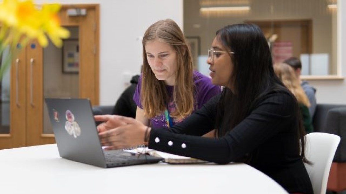 Students watching podcast on laptop