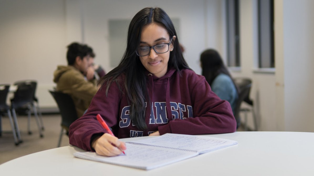 Student revising at desk