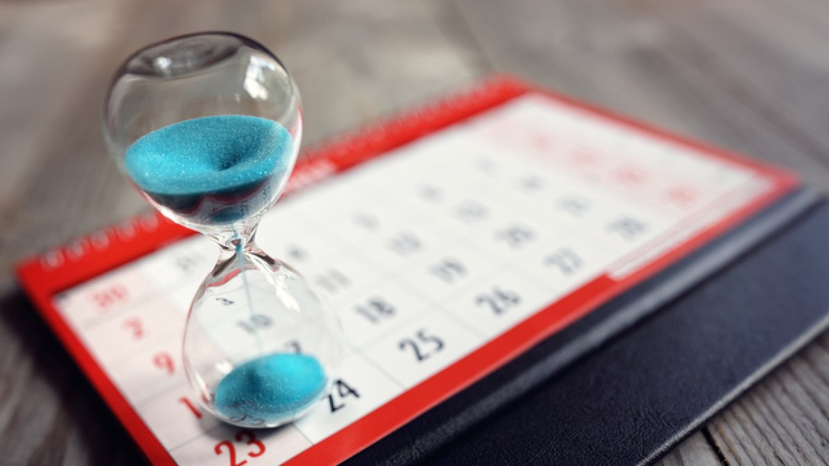 Egg timer on top of a calendar