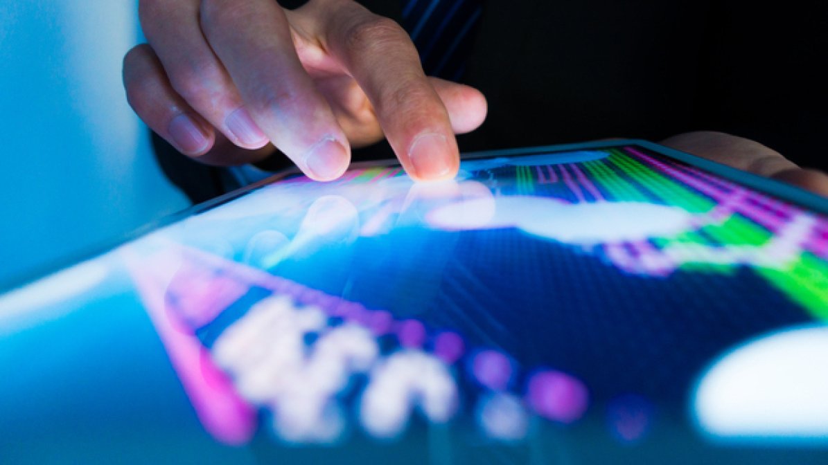 Hand pointing to digita graph on tablet 