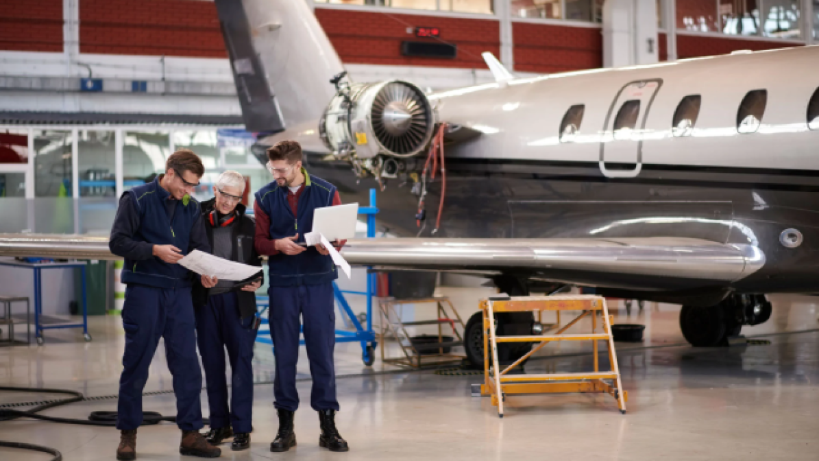 Work experience students in an aircraft hanger with tutor