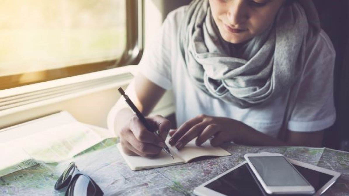 Student on a train studying a map 