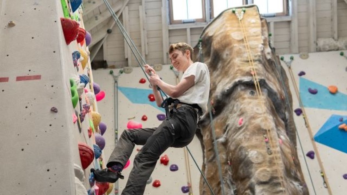 Criminology student on a climbing wall