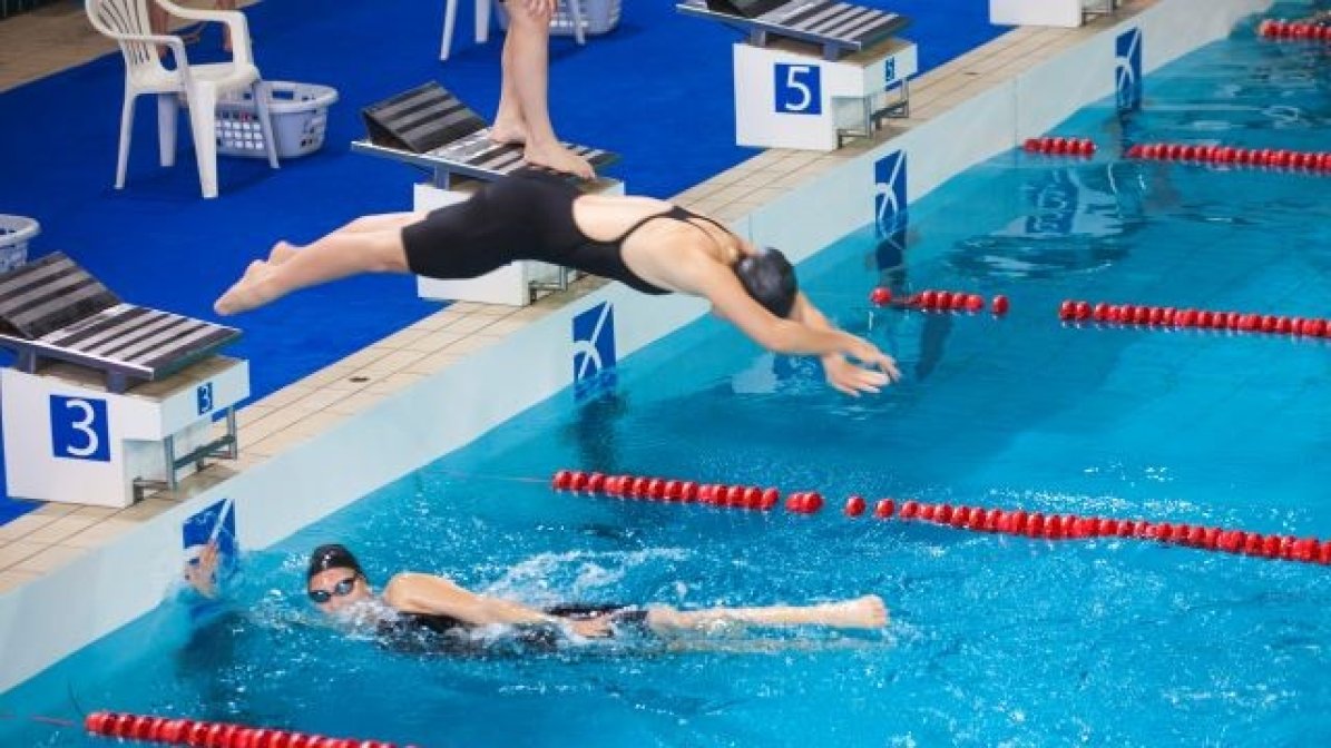 Swimmer diving into a pool