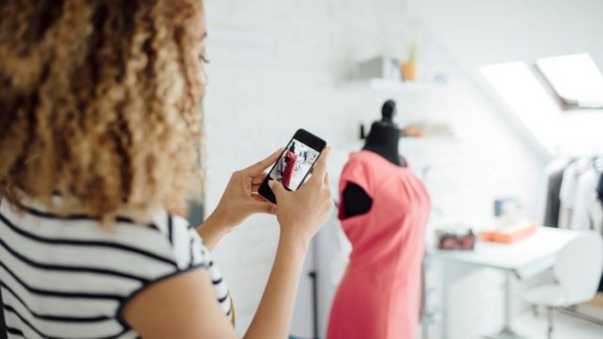 Fashion student taking photo of homemade dress 