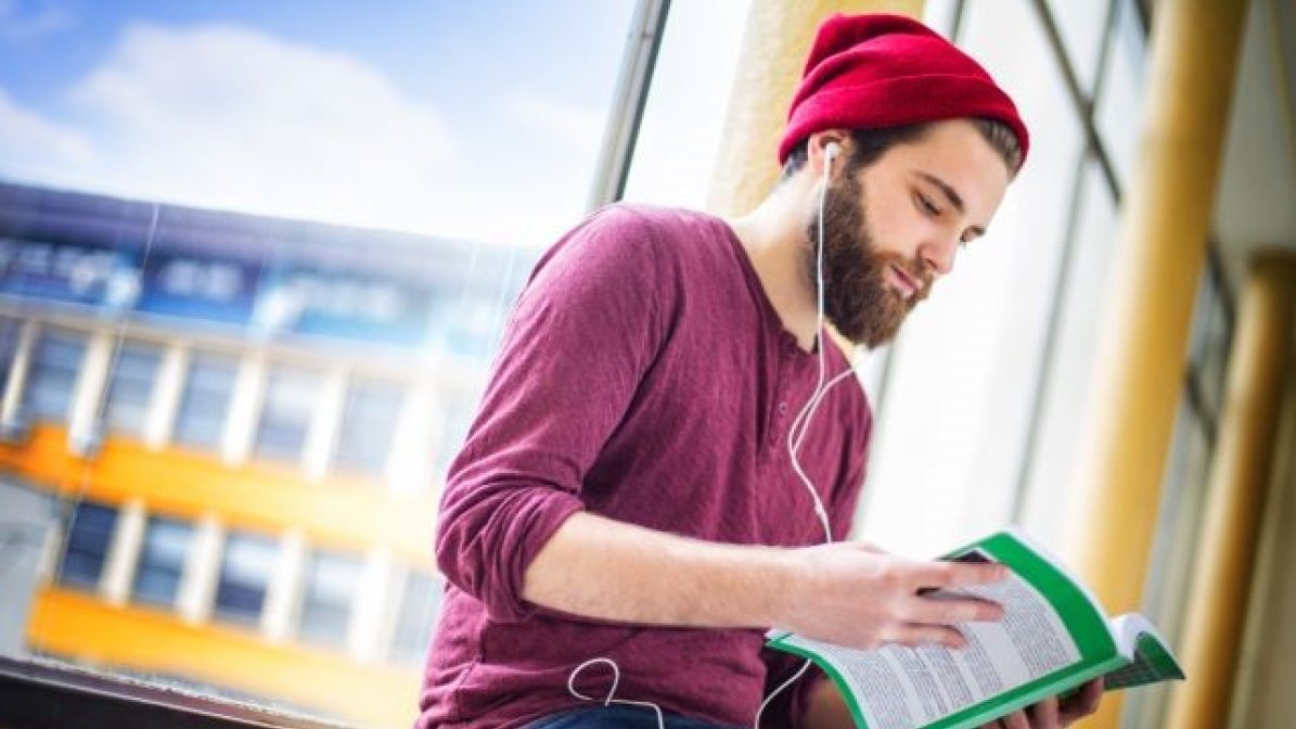 Student listening to podcast on earphones