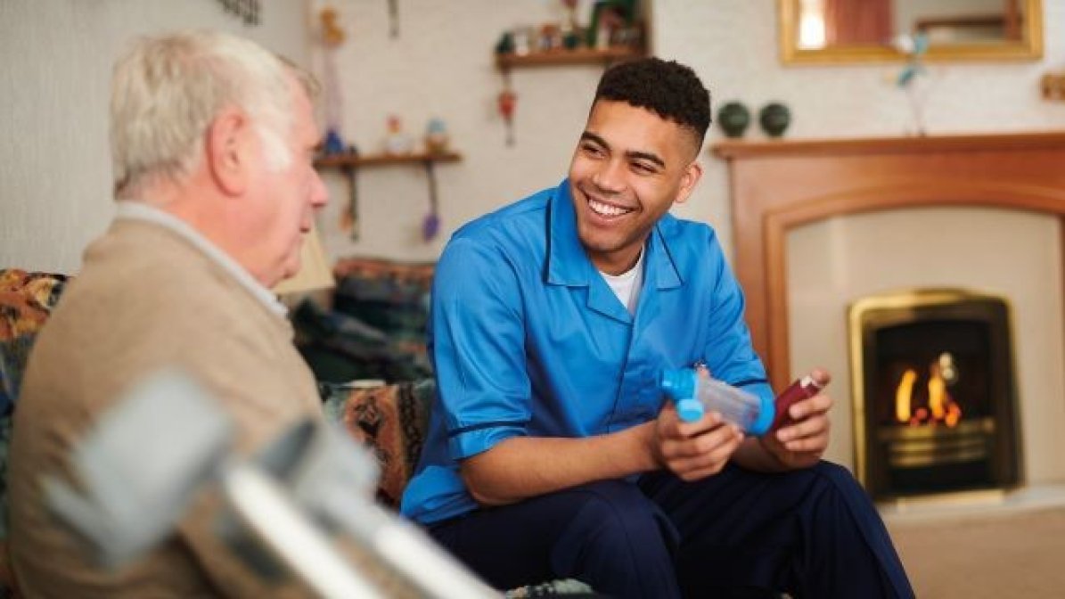 Healh visitor with man in living room