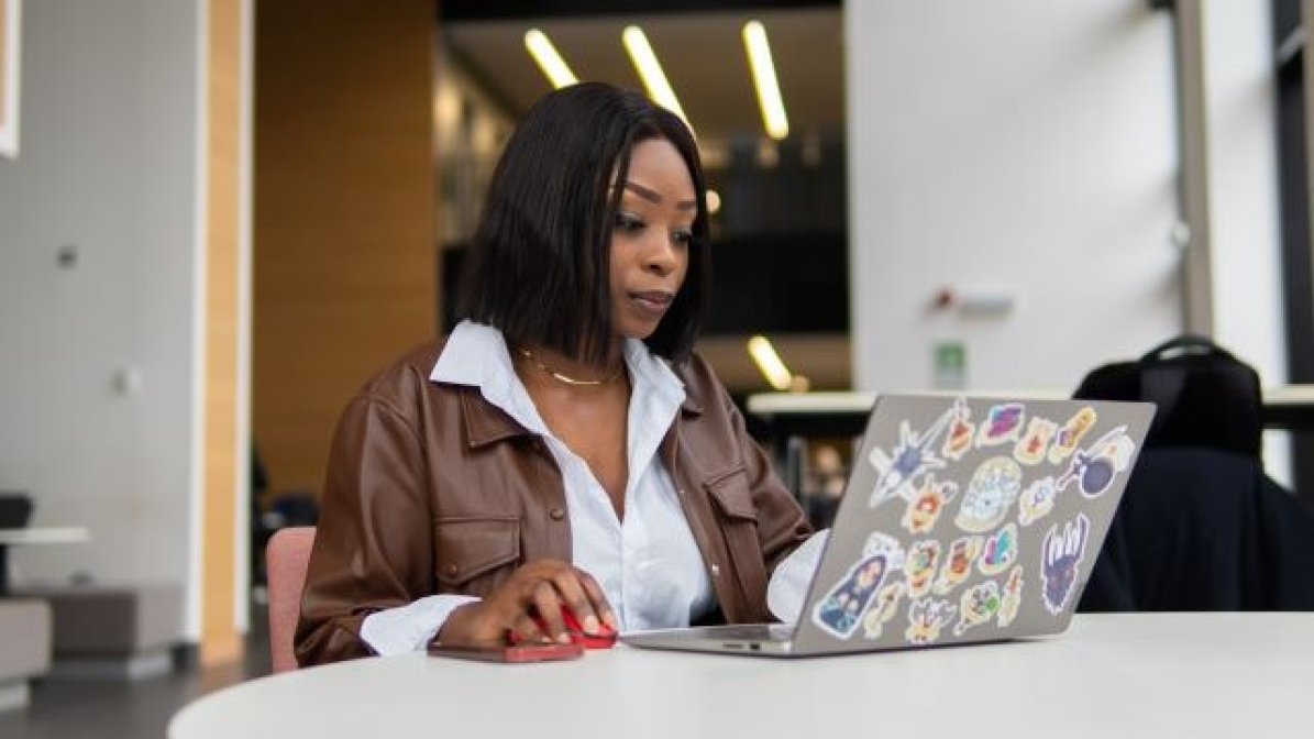 Student researching coures on laptop 