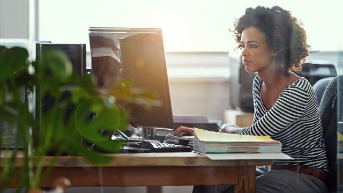 Business management student working on laptop