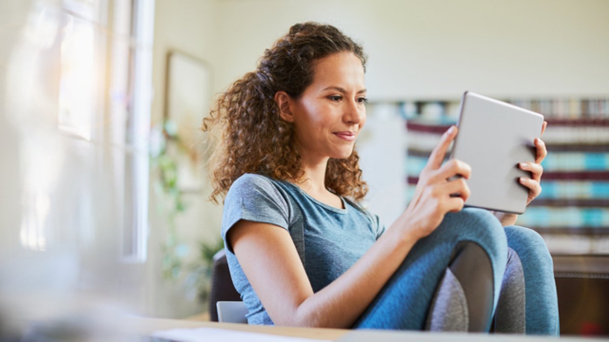 Smiling student using laptop