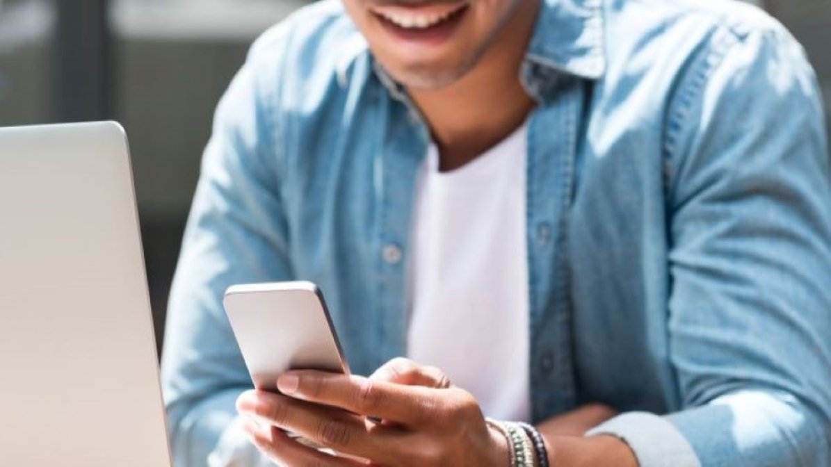 Student using mobile phone and laptop