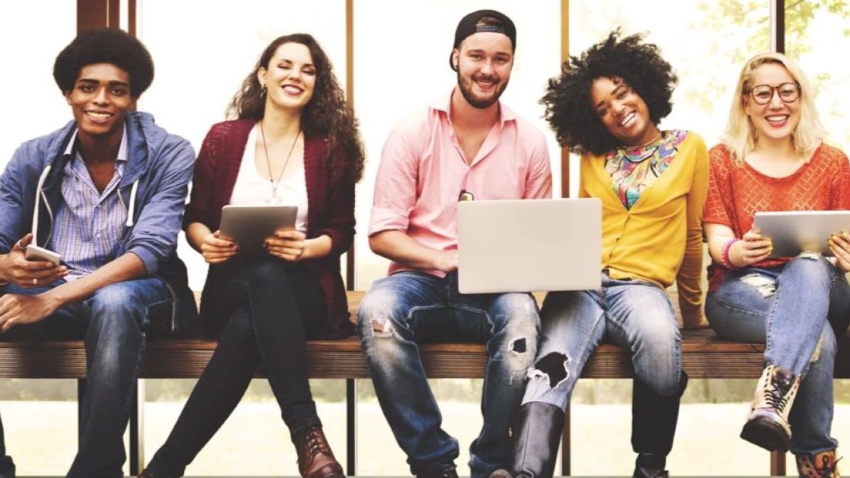 Smiling students sitting on a bench