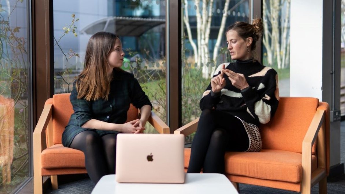 Student parents chatting in uni communal area