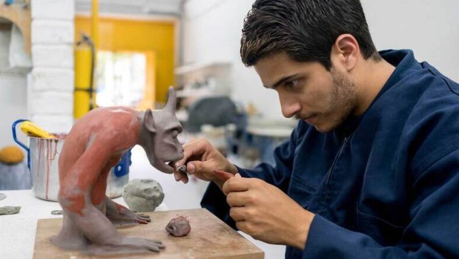 Creative and design student making a clay model