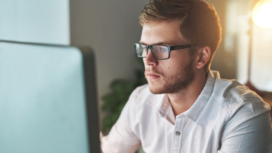 Business and admin apprentice working on laptop