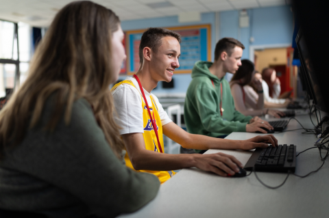 Students sat looking at computer screens in a classroom