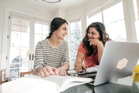 Parent helping child research apprenticeships online 