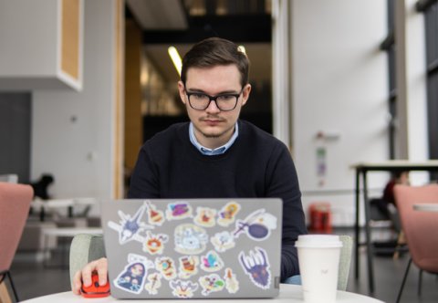 Student writing personal statement on laptop