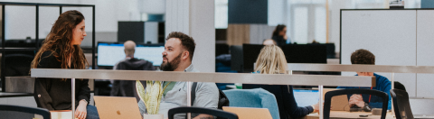 UCAS staff having a conversation in the Rosehill office, Cheltenham