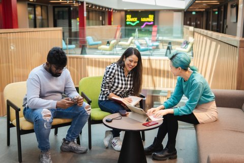 Students chatting around table in university