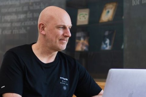 Independent referee writing a reference on laptop