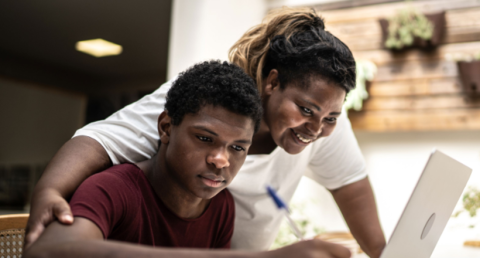 Parent and child looking at post-school options on laptop