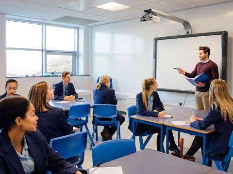 Teacher at the front of a class of high school students