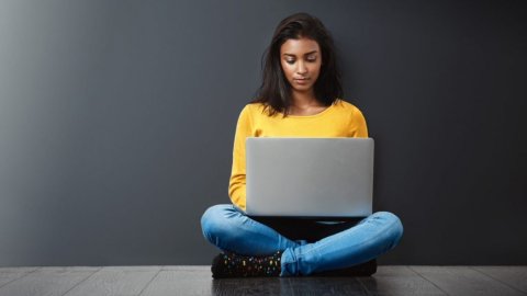 A student looks at their laptop