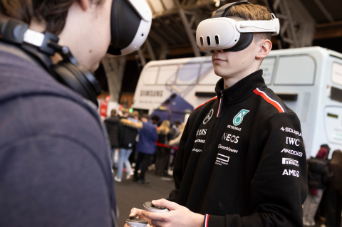 Students using a VR headset at a UCAS event.