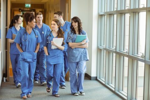 Trainee doctors walking in hospital corridor
