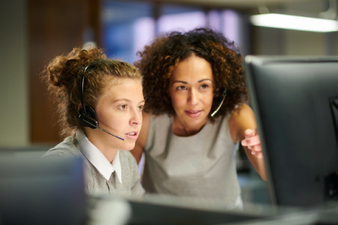 Adviser helping student on PC