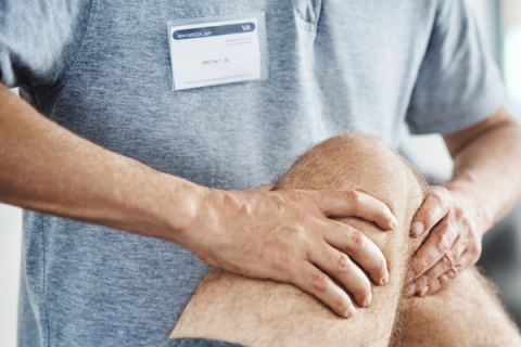 Physiotherapist working on patient's leg