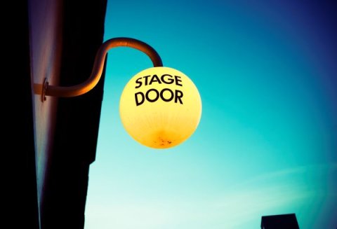 Stage door sign against the night sky